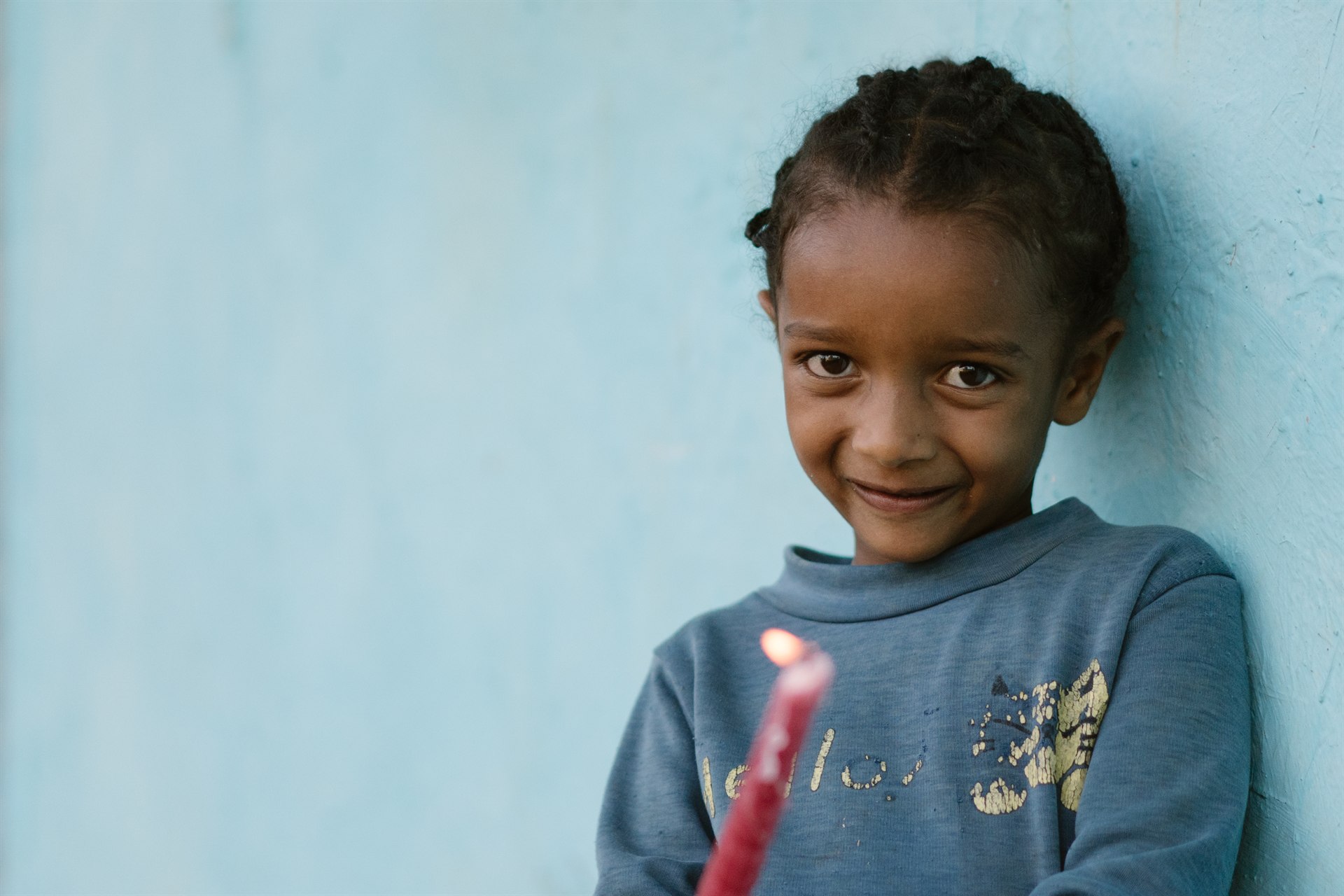 Child holding candle, Ethiopia